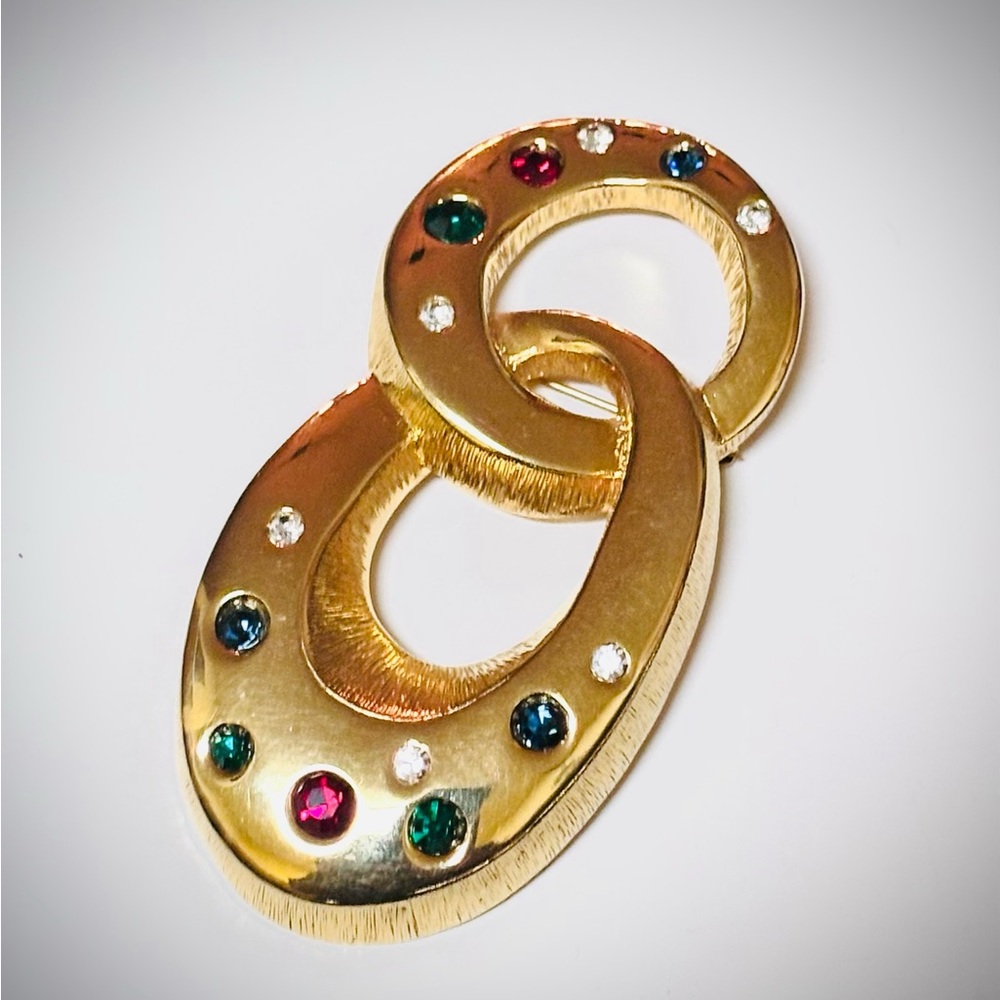 Elegant Les Bernard Gold-Tone Linked Brooch with Multicolor Gems